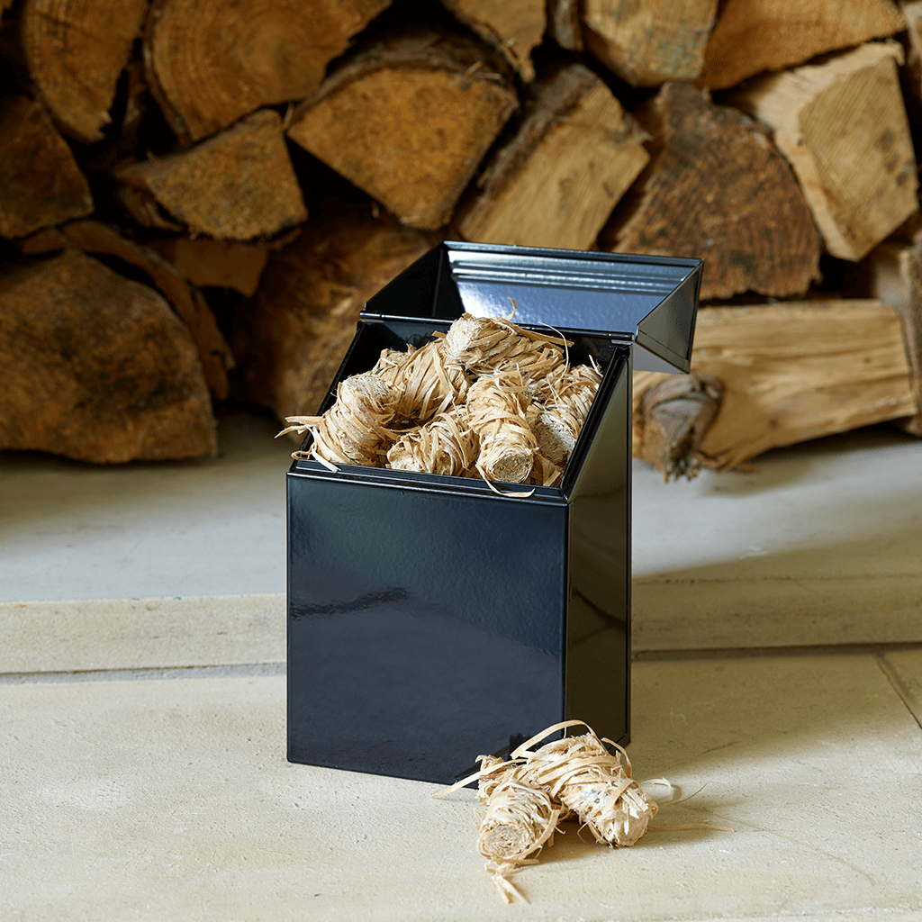 Valiant Firelighter Tidy open, filled with eco-friendly firelighters, sitting on hearth with logs