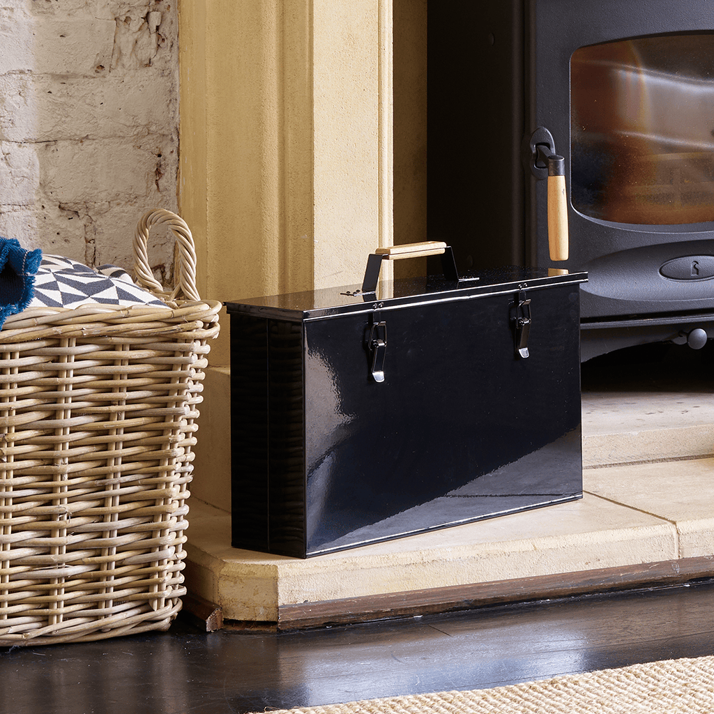 Lifestyle image of Valiant Fireside Tidy sitting on a hearth next to a wood burning stove 