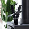 A photo of the Vanquish 250 Fan sitting on a stove top in a conservatory with a green cactus behind.